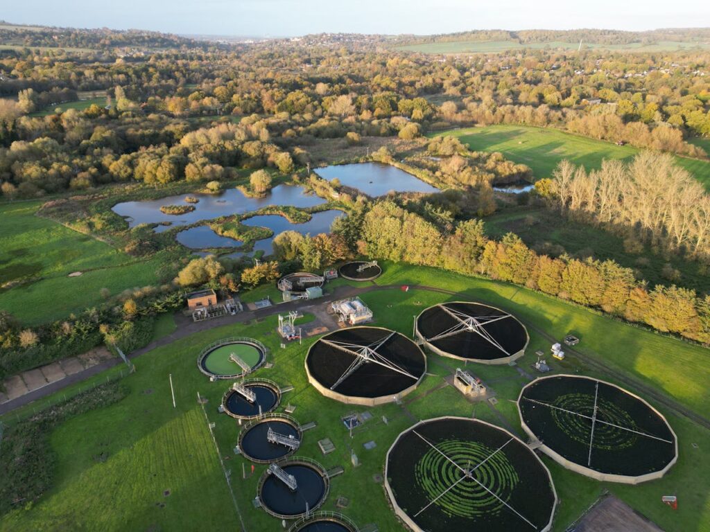 Drone shot of a picturesque rural water treatment plant surrounded by nature.