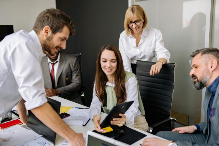 Diverse team collaborating with digital tablet during an office meeting. Perfect for business and teamwork themes.