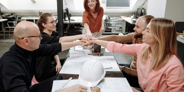 Architects collaborate on project plans in a modern office setting.